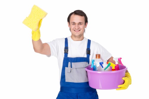 Carpet cleaning technician preparing a safe work area with protective equipment